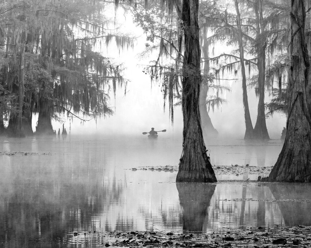 Kayaker paddling into mist