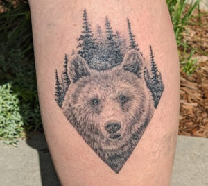 Grizzly bear and forest tattoo